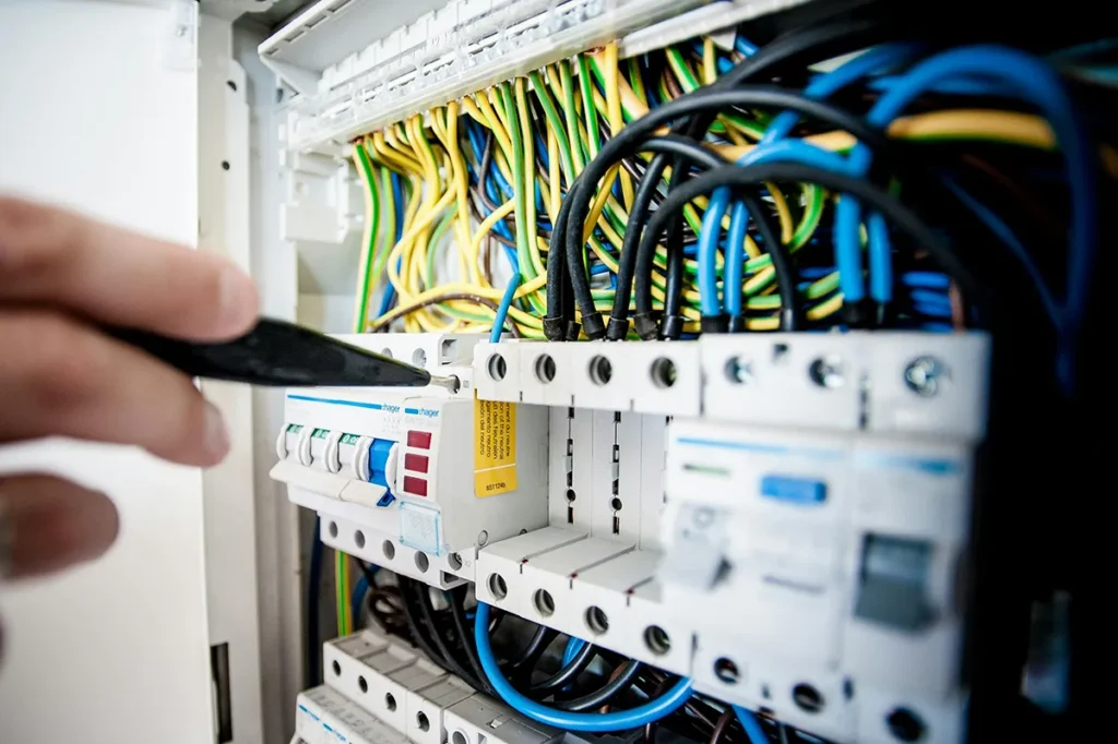 Electrical Panel with electrician unscrewing a screw in it